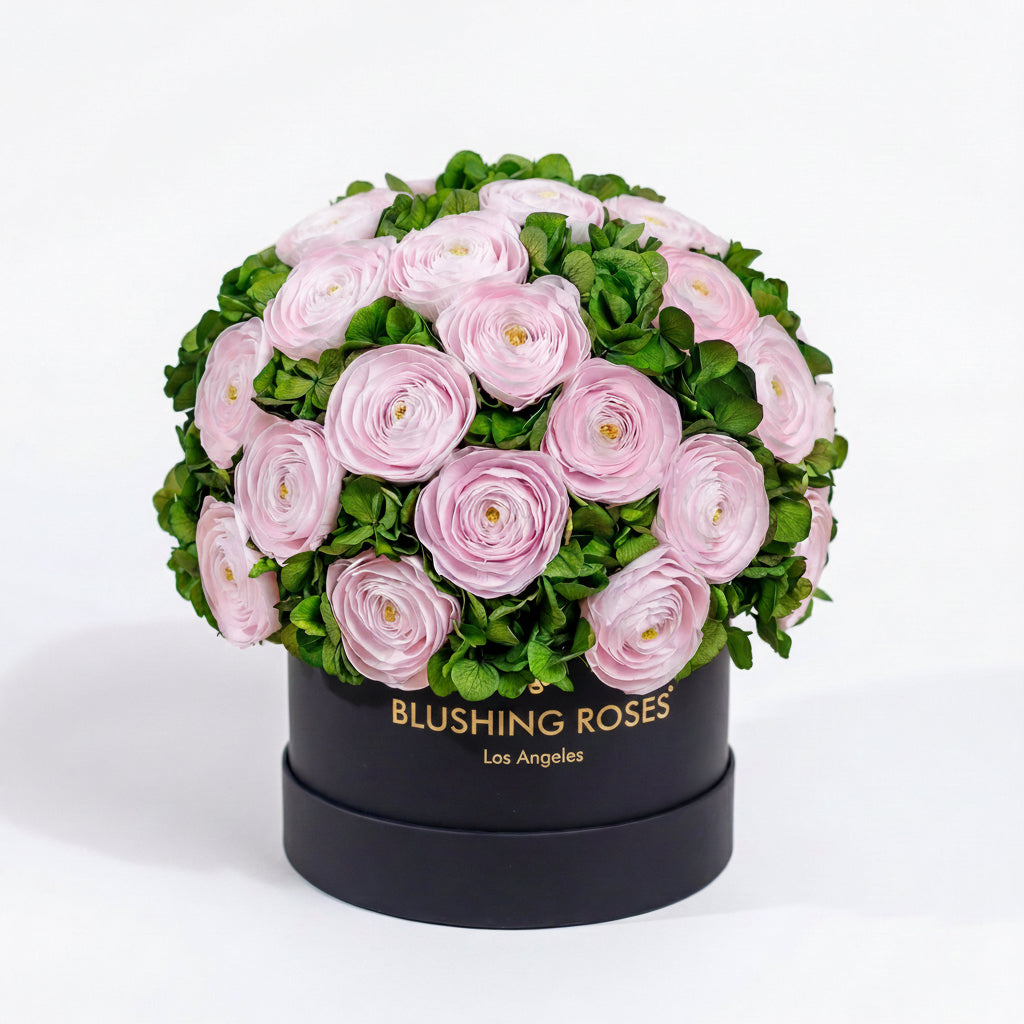 Round black box with pink flowers and green leaves, branded 'Blushing Roses' on a white background