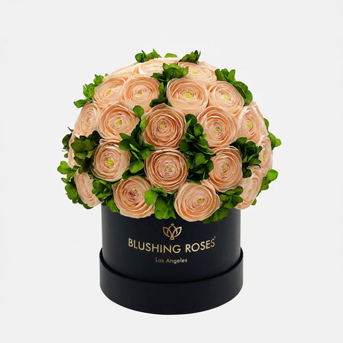 Luxury peach preserved roses with green hydrangeas in black flower box, elegant forever roses arrangement for luxury home décor | Blushing Roses Floral arrangement in a black box with Blushing  Roses' branding on a white background