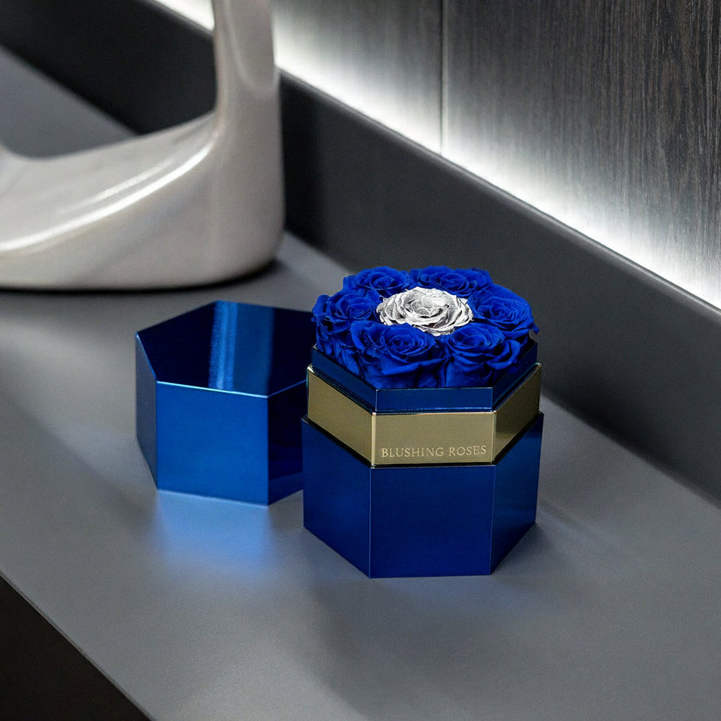 luxury preserved blue roses in a hexagon royal blue box by blushing roses featuring forever roses arrangement for girts, anniversaries, birthdays, mother's day, and luxury home decor