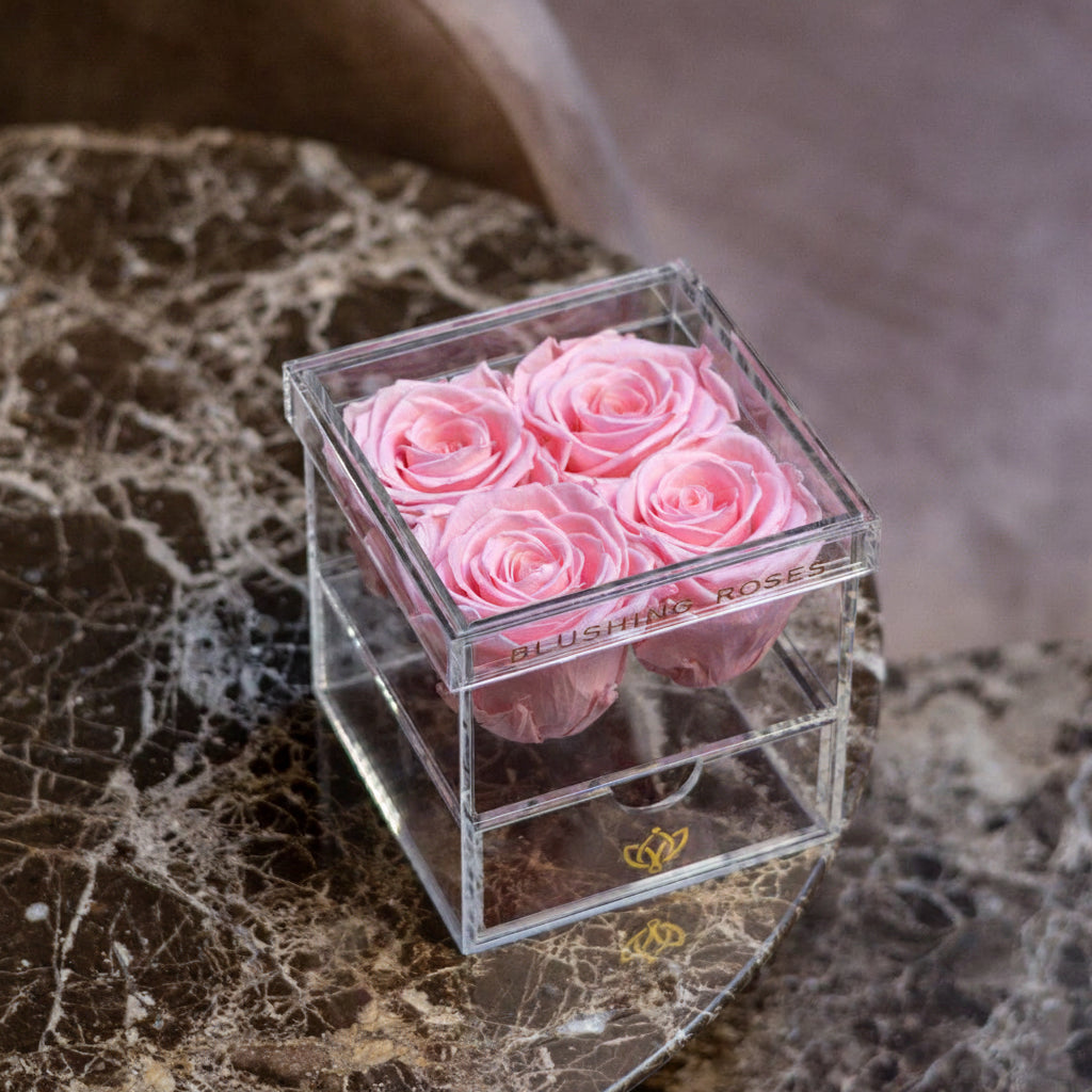     Luxury pink forever roses in acrylic drawer box, preserved rose arrangement for Valentine’s Day, Mother’s Day, and elegant gifts | Blushing Roses Clear cube with pink roses on a marble surface
